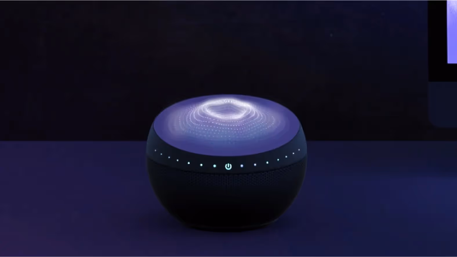 a computer monitor and a speaker on a desk