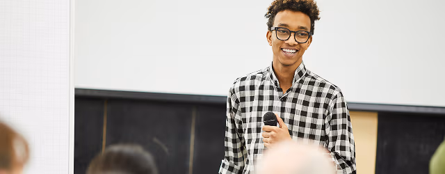 a person presenting in front of an audience