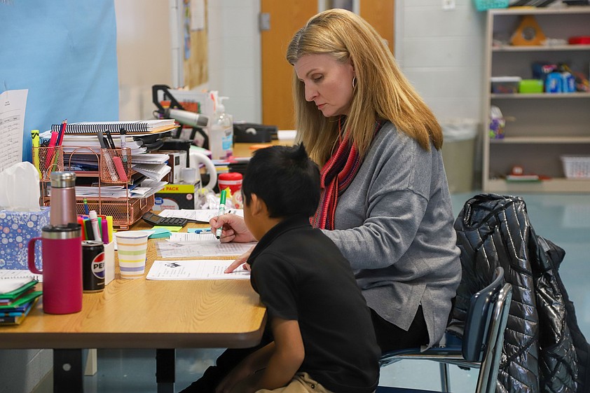 Staff photo / Lisa Turner works with a student Jan. 30, 2024, during a tutoring session at East Side Elementary School. The literacy tutoring program that was piloted at the school during the 2023-24 academic year is expanding again to serve more elementary schools in Hamilton County.