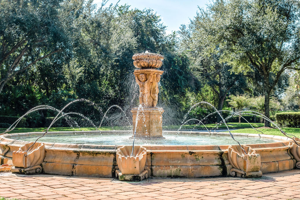 Stone fountain centerpiece surrounded by trees in Live Oak Reserve, Oviedo FL
