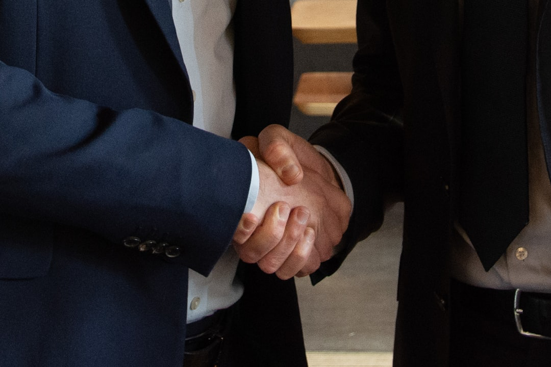 Handshake sealing a business deal - company due diligence