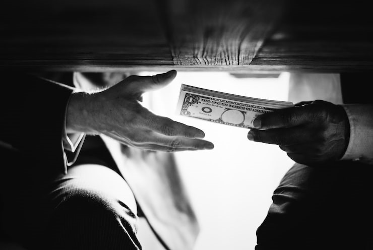 Hands passing money under the table corruption and bribery, Picture