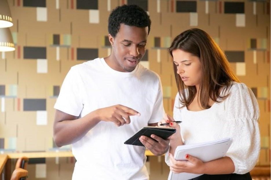 Happy African American designer presenting project to client on tablet and smiling. Sanction checking