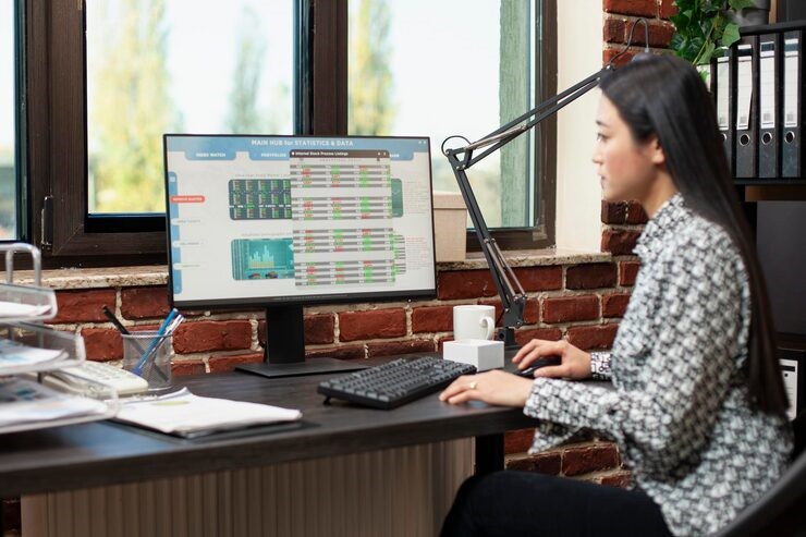 Woman reviewing business data reports, Picture, AML ID verification