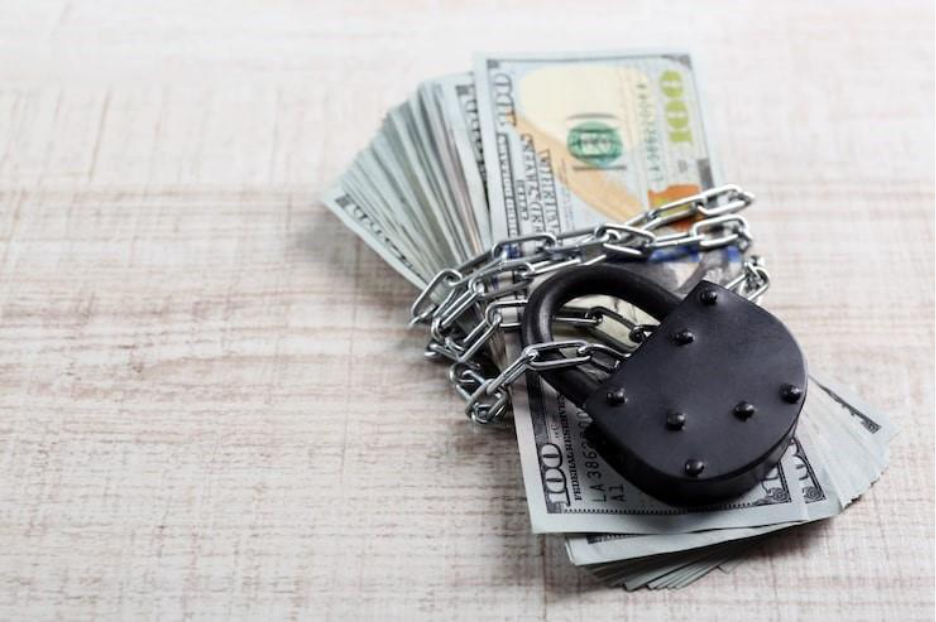 Dollars currency with lock and chain on wooden table backgroundAnti Money Laundering Checks