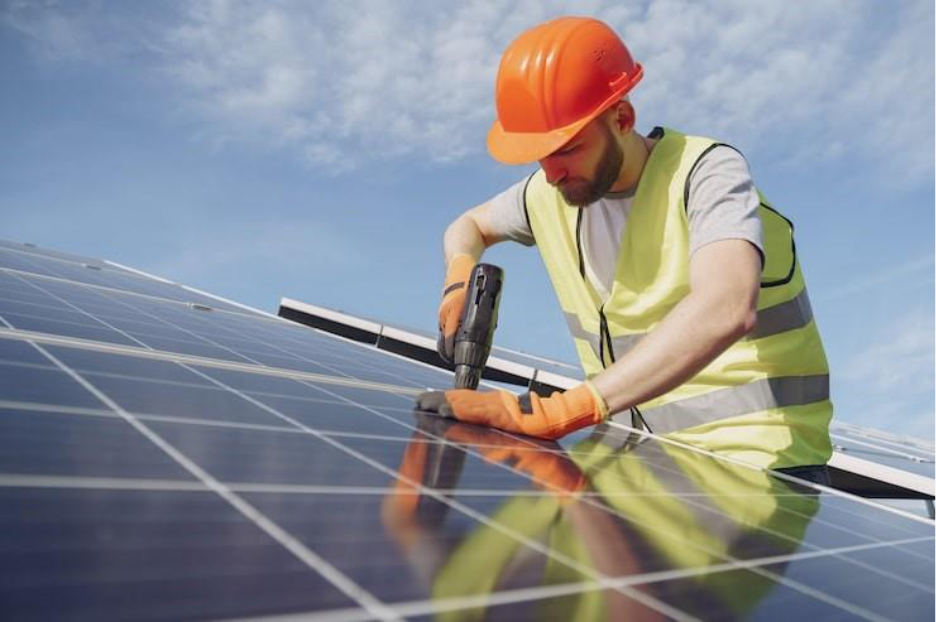 Alternative energy ecological concept. Construction man putting together solar panels. 