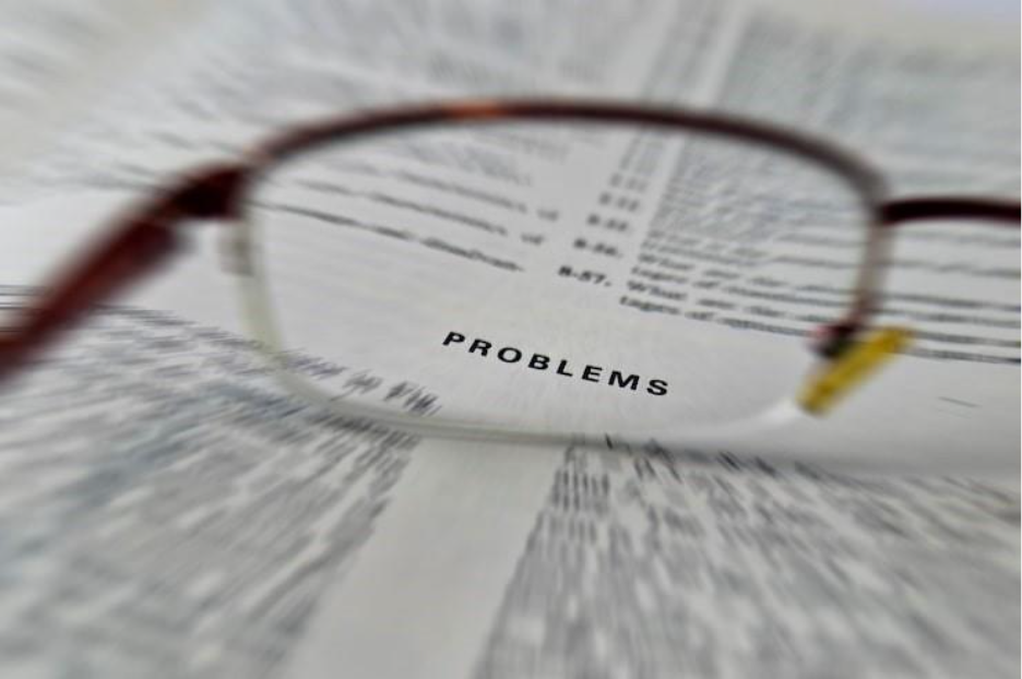 Close-up of eyeglasses on book, representing practices for detecting