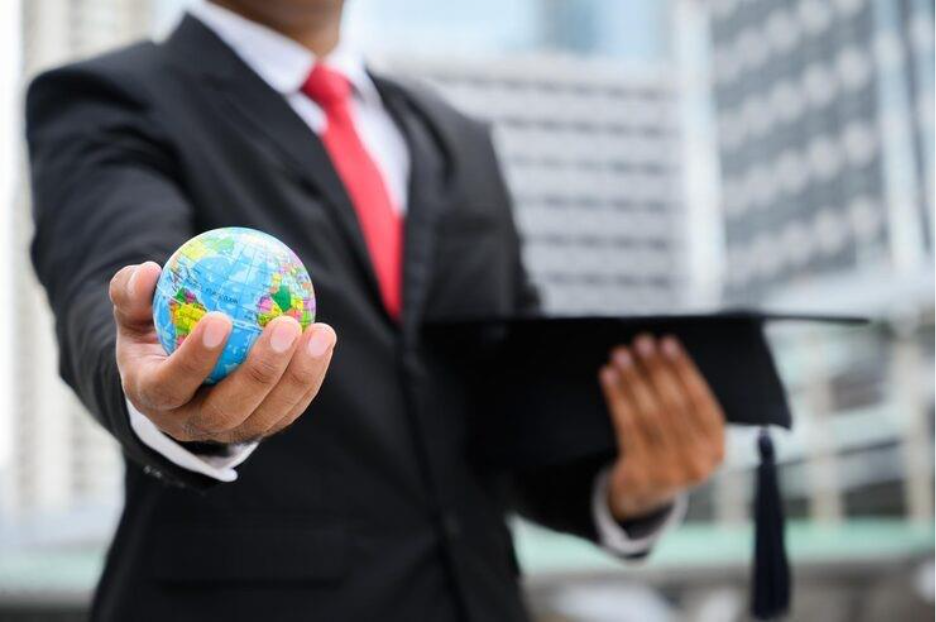 Midsection of businessman holding globe, representing how Foreign Investors Need to Verify U.S. Companies .