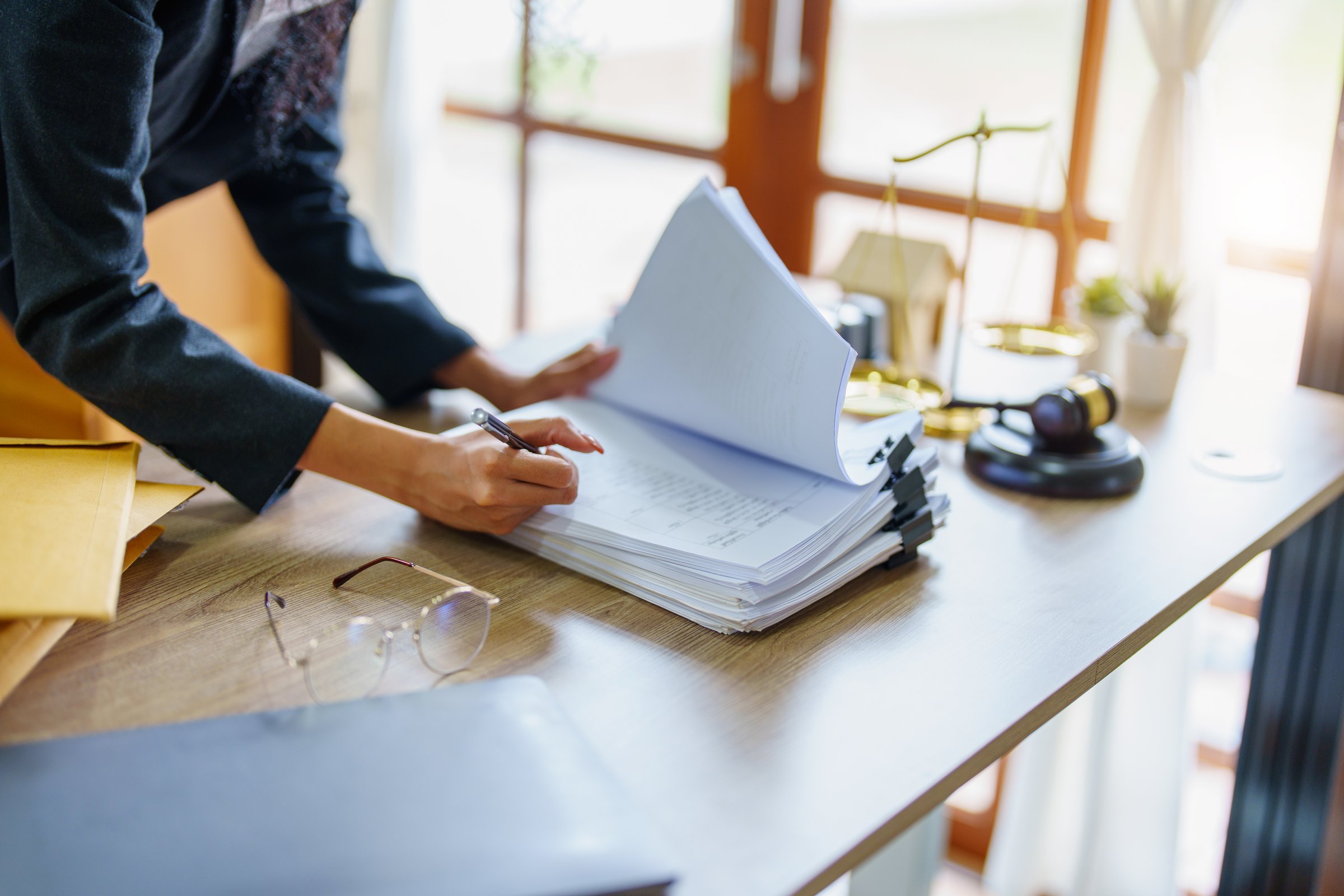 Reviewer at a desk comparing documents during business identity verification