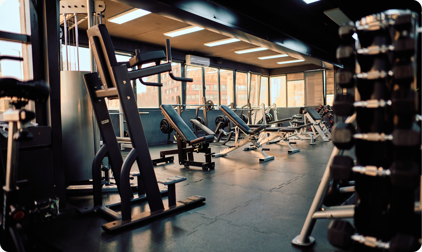 An empty modern gym with strength-training equipment.