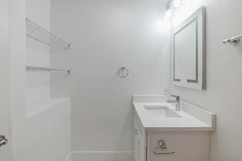 Modern white bathroom with sink and vanity.