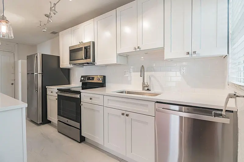 Modern galley kitchen with stainless steel appliances.