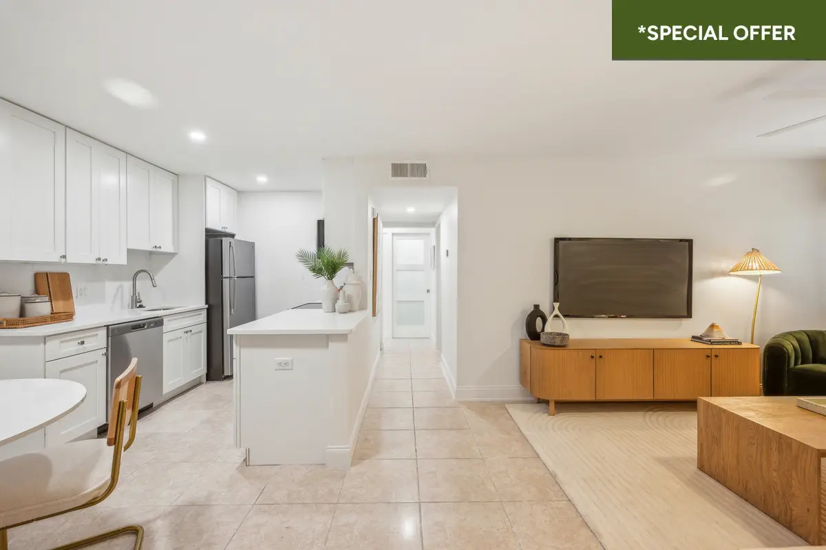 Open floorplan living dining and kitchen with gorgeous breakfast bar, white cabinets, and dishwasher with text overlay stating "*special offer."