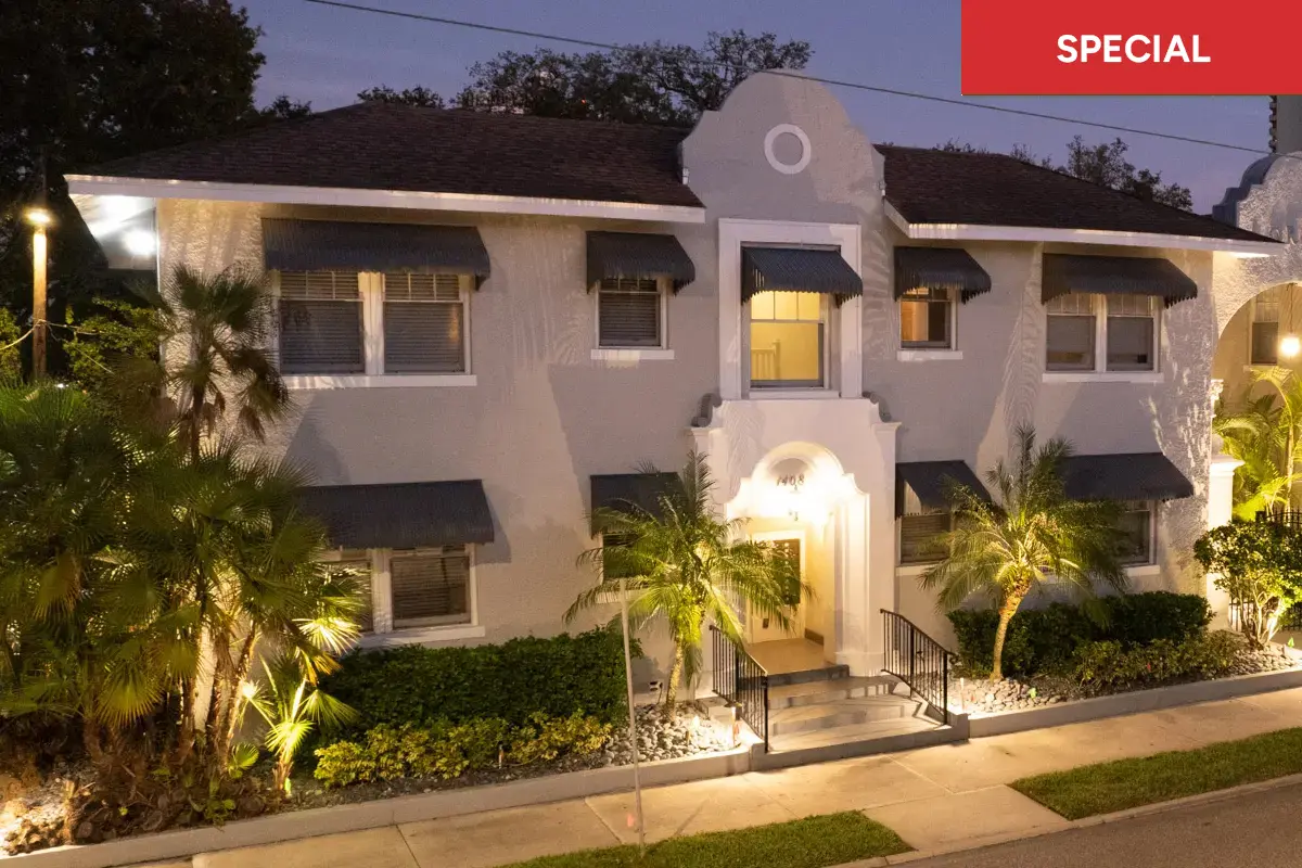 View of front facade of apartment building with with gated fountain courtyard with archy way stating "Lorenzo" with text overlay stating "special."