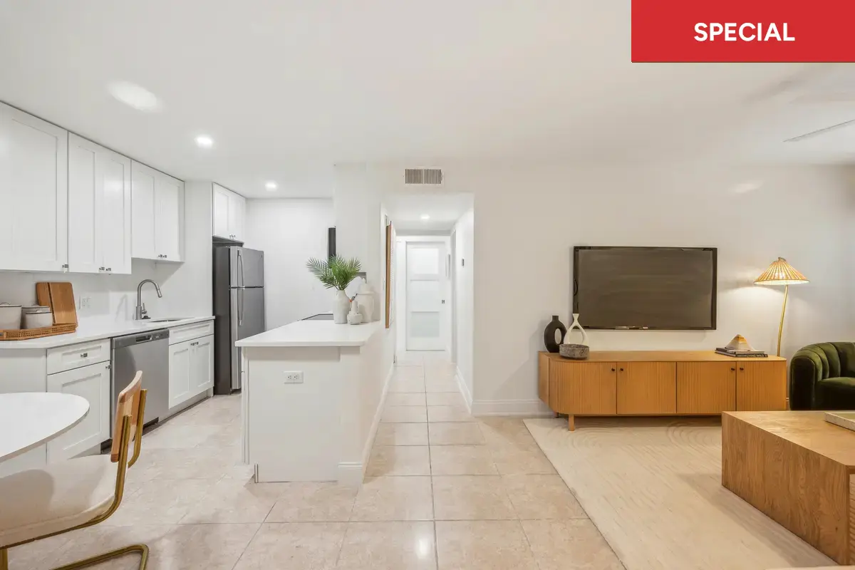 Open floorplan living dining and kitchen with gorgeous breakfast bar, white cabinets, and dishwasher with text overlay stating "special."