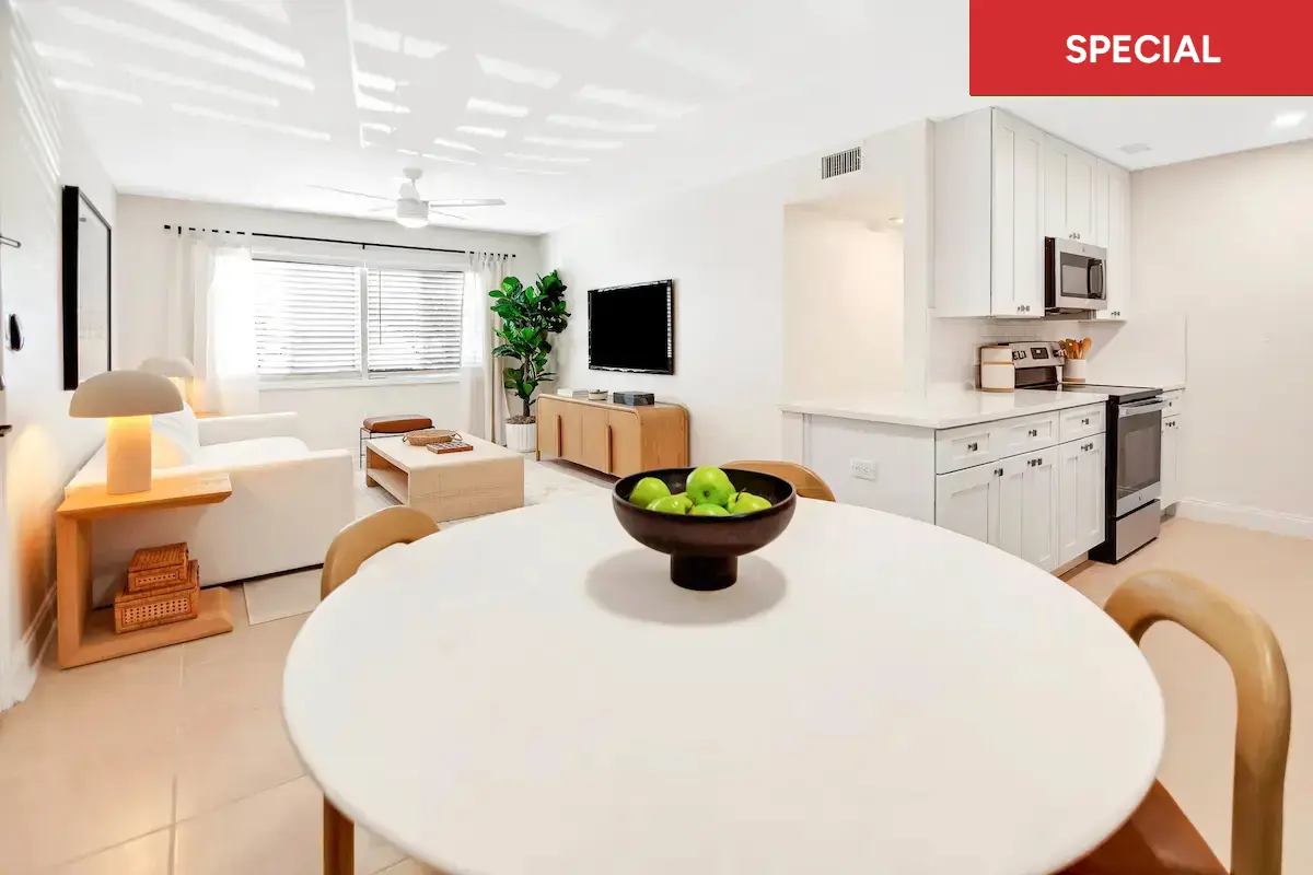 Contemporary dining room off of living room with a large window, potted plant, and minimalist decor with text overlay stating "special."