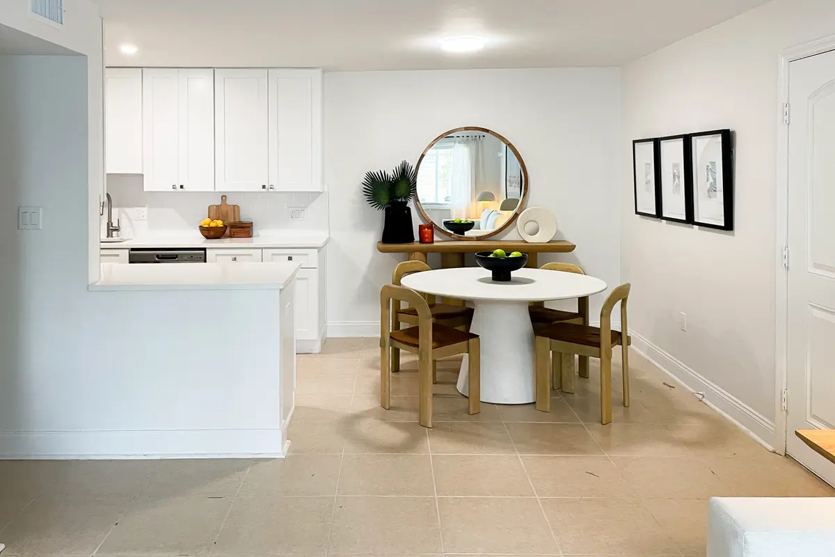 Contemporary dining room off of living room and kitchen with minimalist decor.