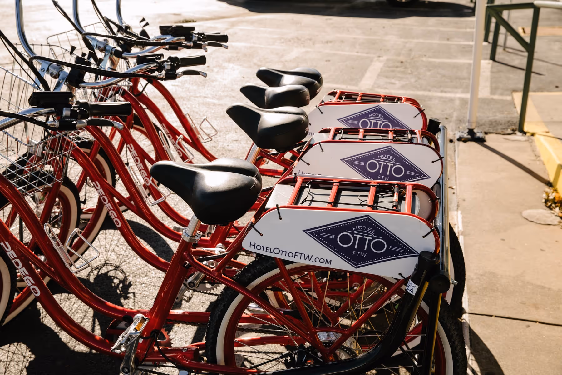 Hotel Otto's branded red Pedego electric cruiser bikes lined up at the property