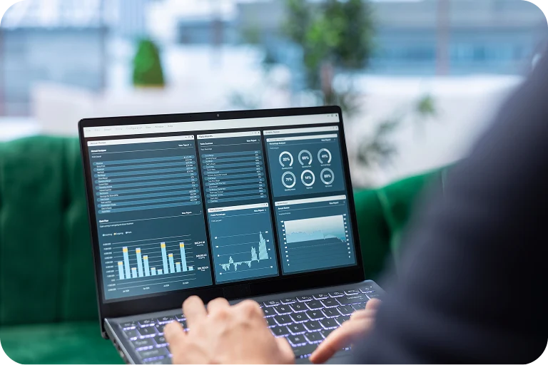 Person analyzing business data and statistics displayed on a laptop screen with charts and graphs.