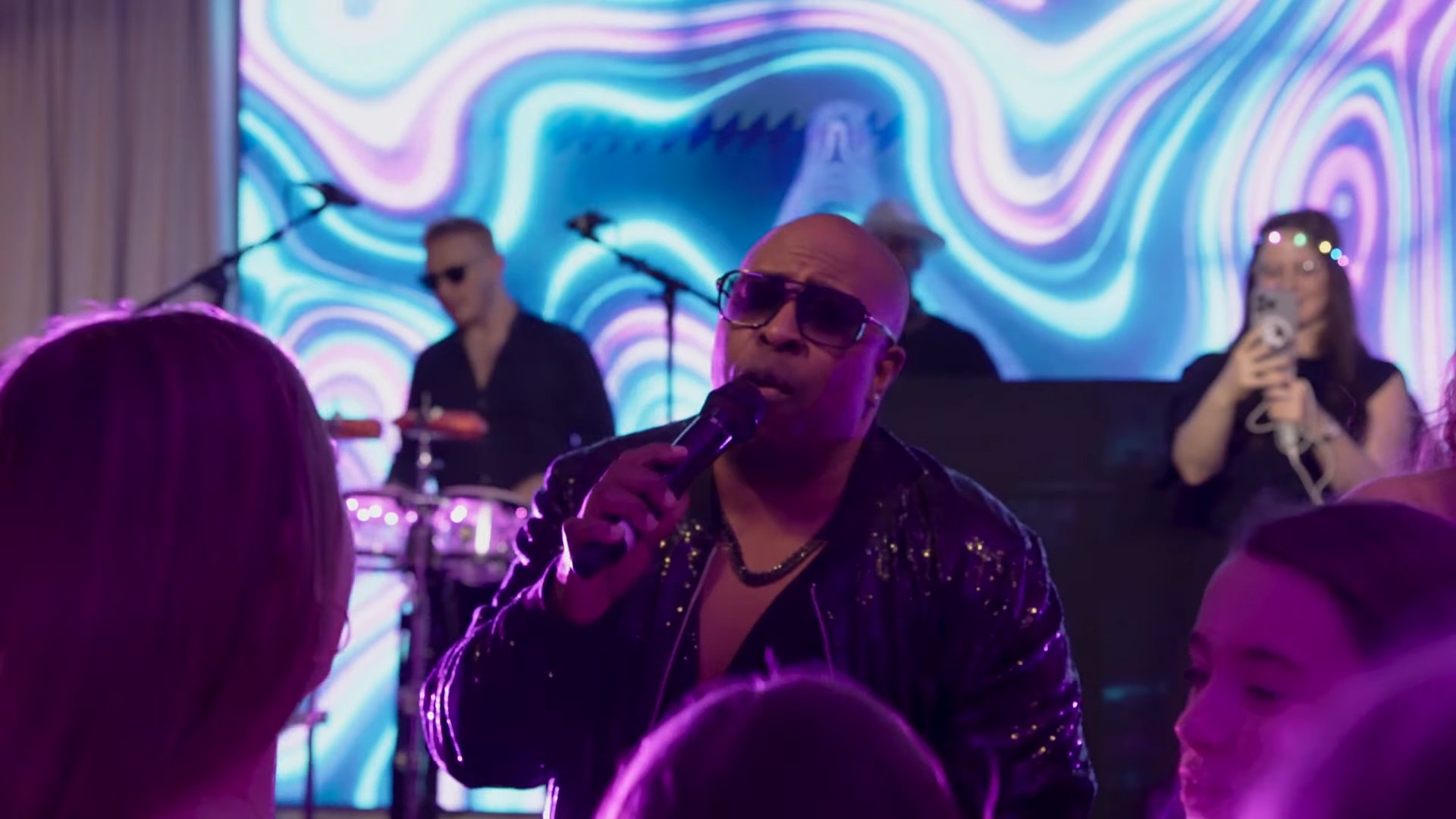 The SuperSonics' lead vocalist performing among guests