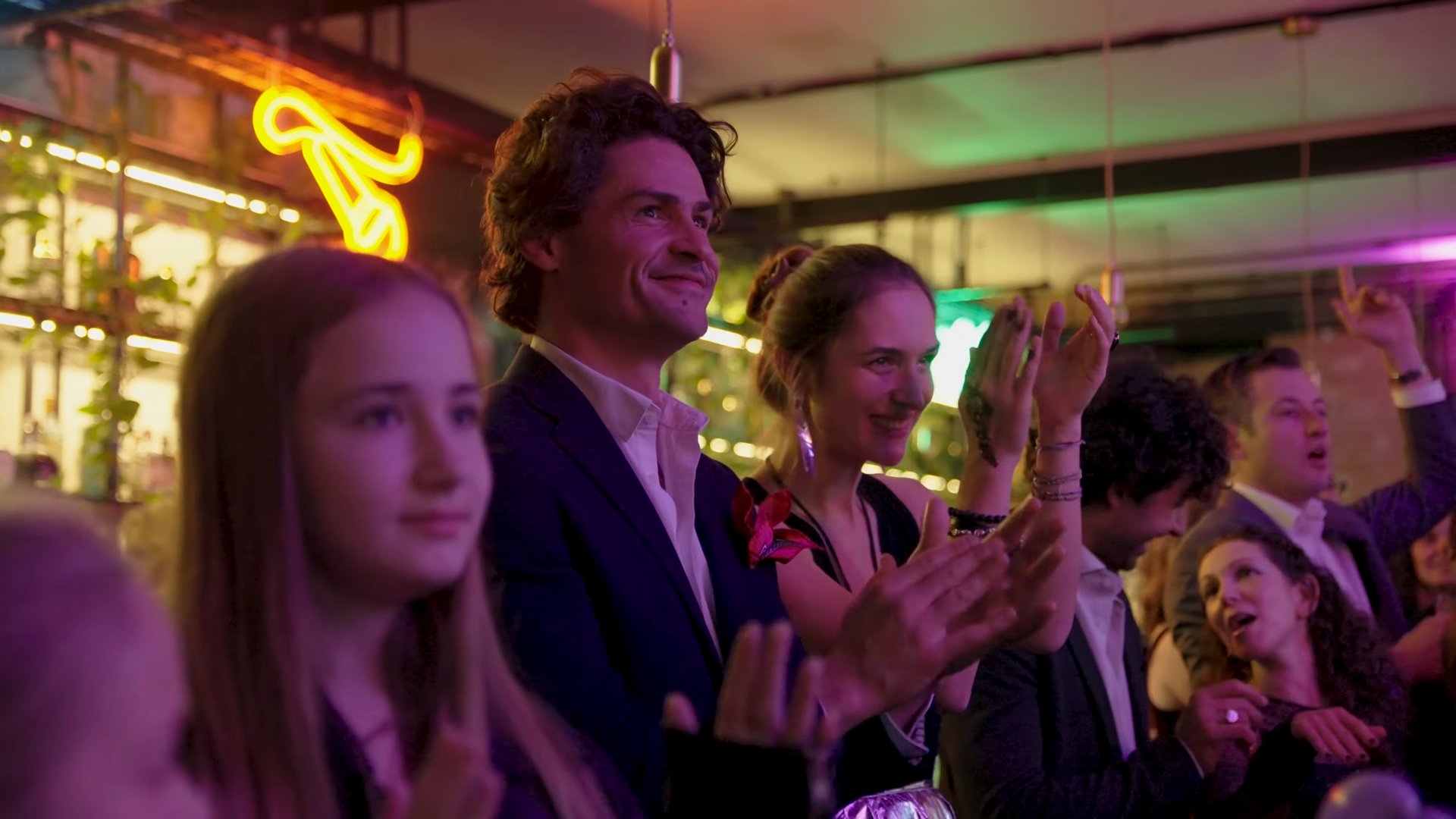 Guests smiling and applauding the entertainment