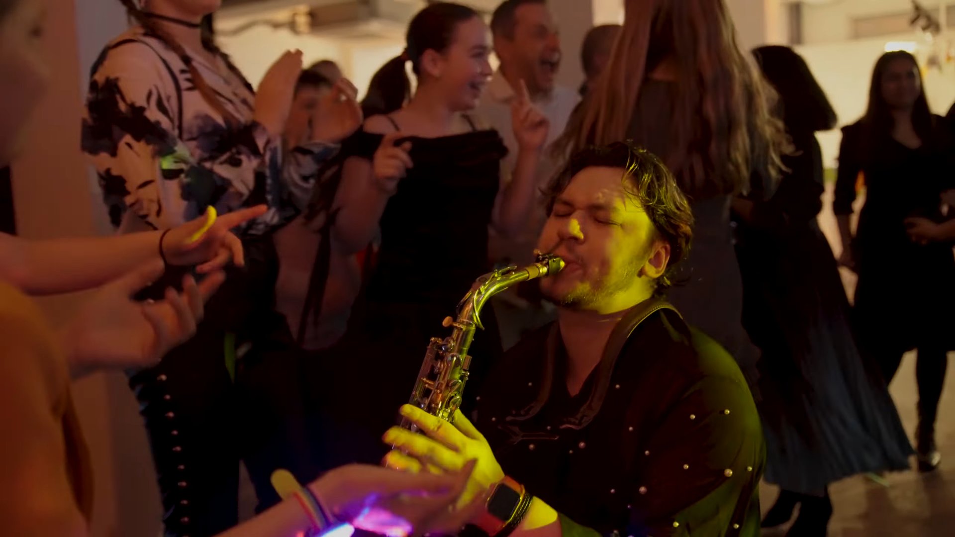 Live roaming saxophonist playing among guests
