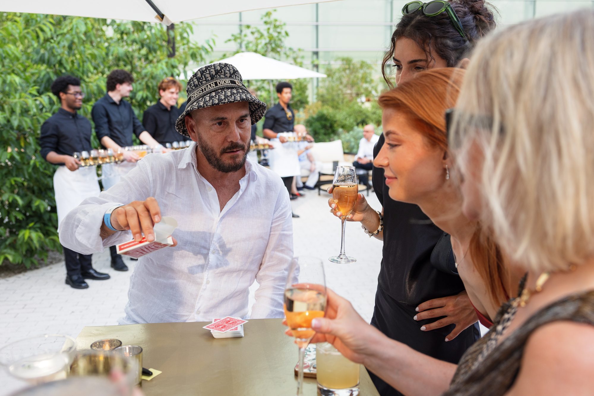 A roaming magician entertains guests during the reception