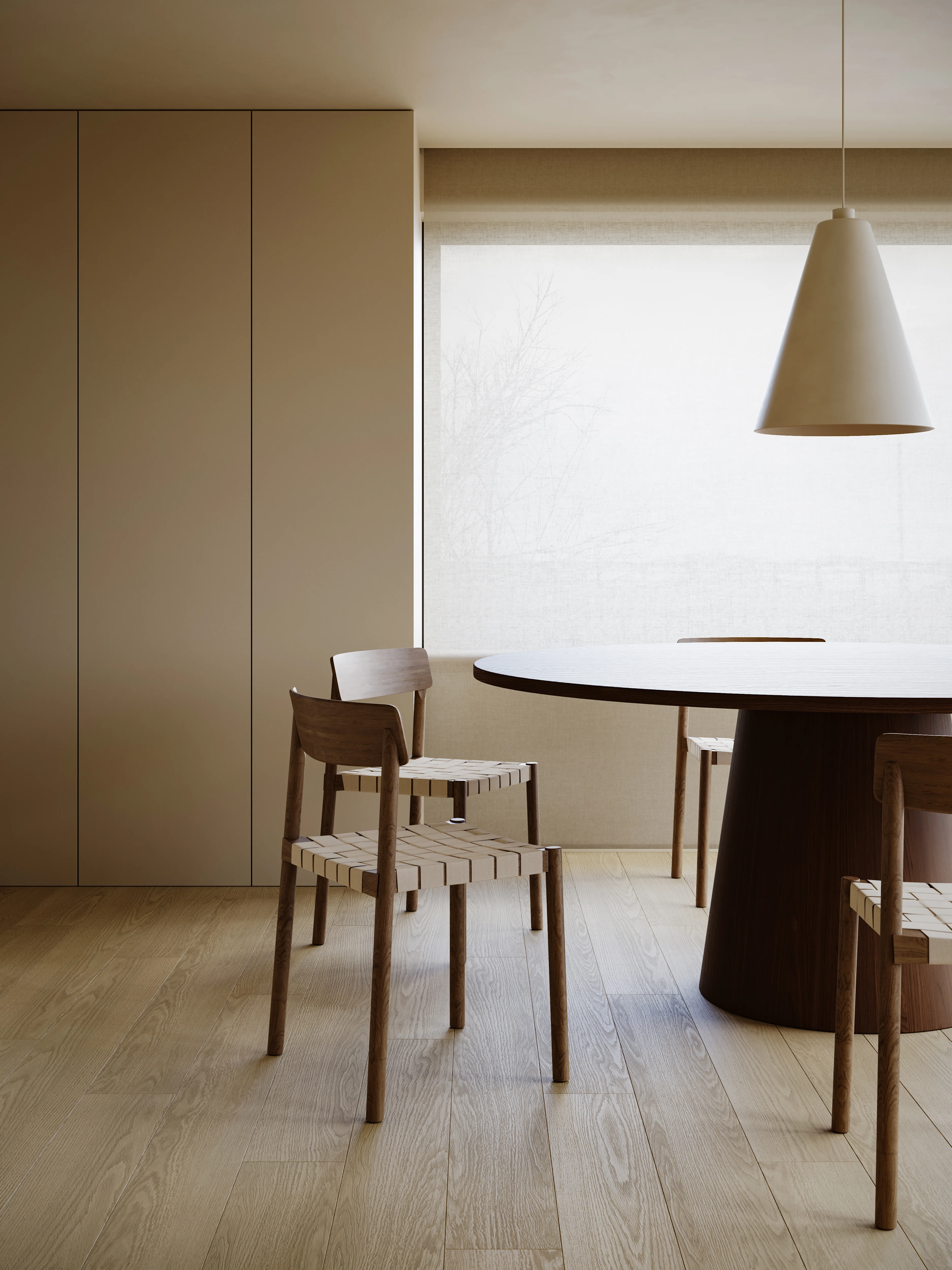 Minimalist dining room with wooden chairs and round table on light hardwood floor under a cone-shaped pendant light.
