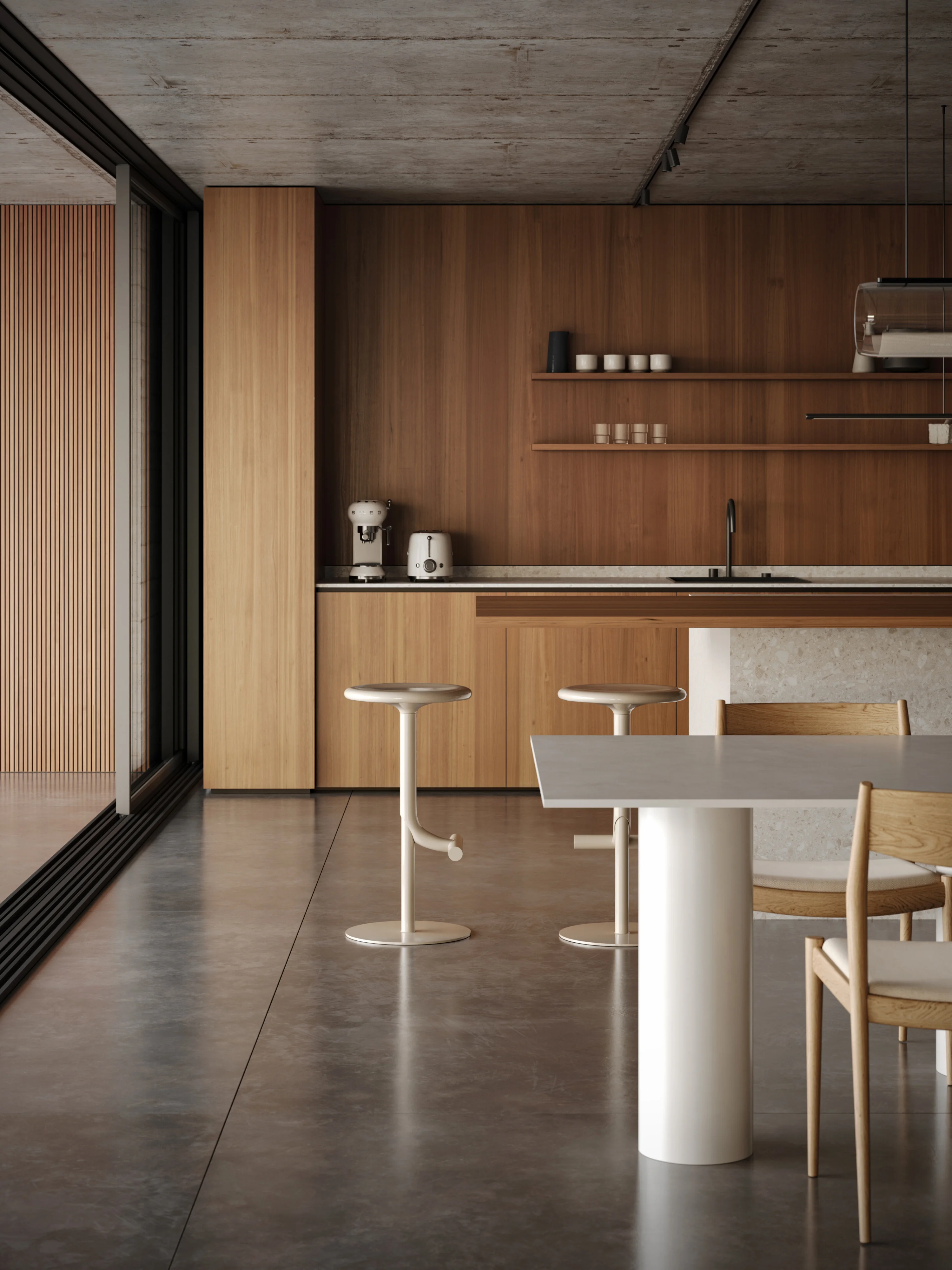 Minimalist kitchen with wooden cabinets, two white bar stools, a white table with wooden chairs, and kitchen appliances on the counter.