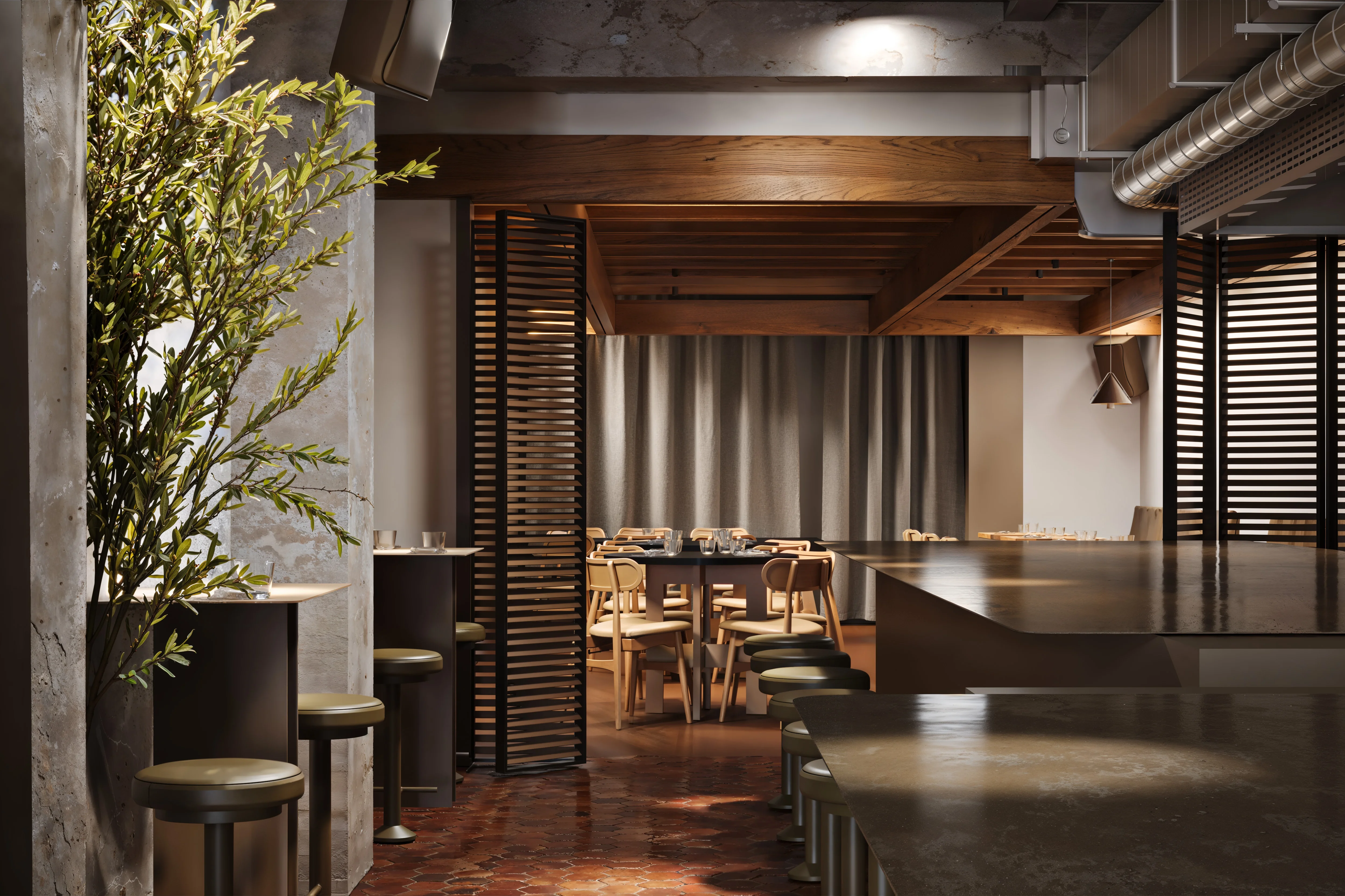 Modern restaurant interior with wooden beams, tall black stools along dark counters, light wooden chairs around a dining table, and a leafy plant near a concrete wall.