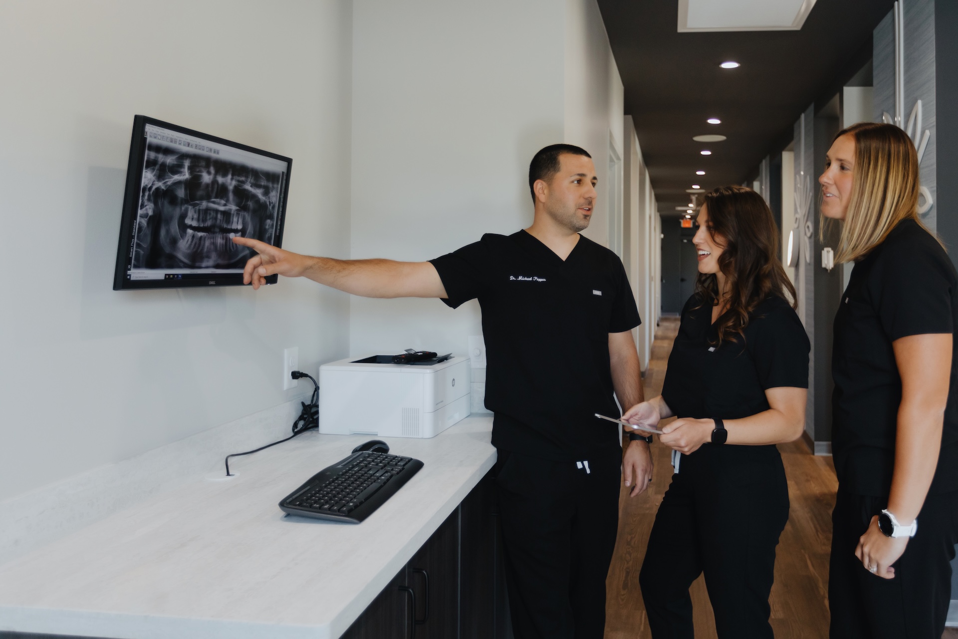 Two dentists being shown an x-ray at Grove City Smiles