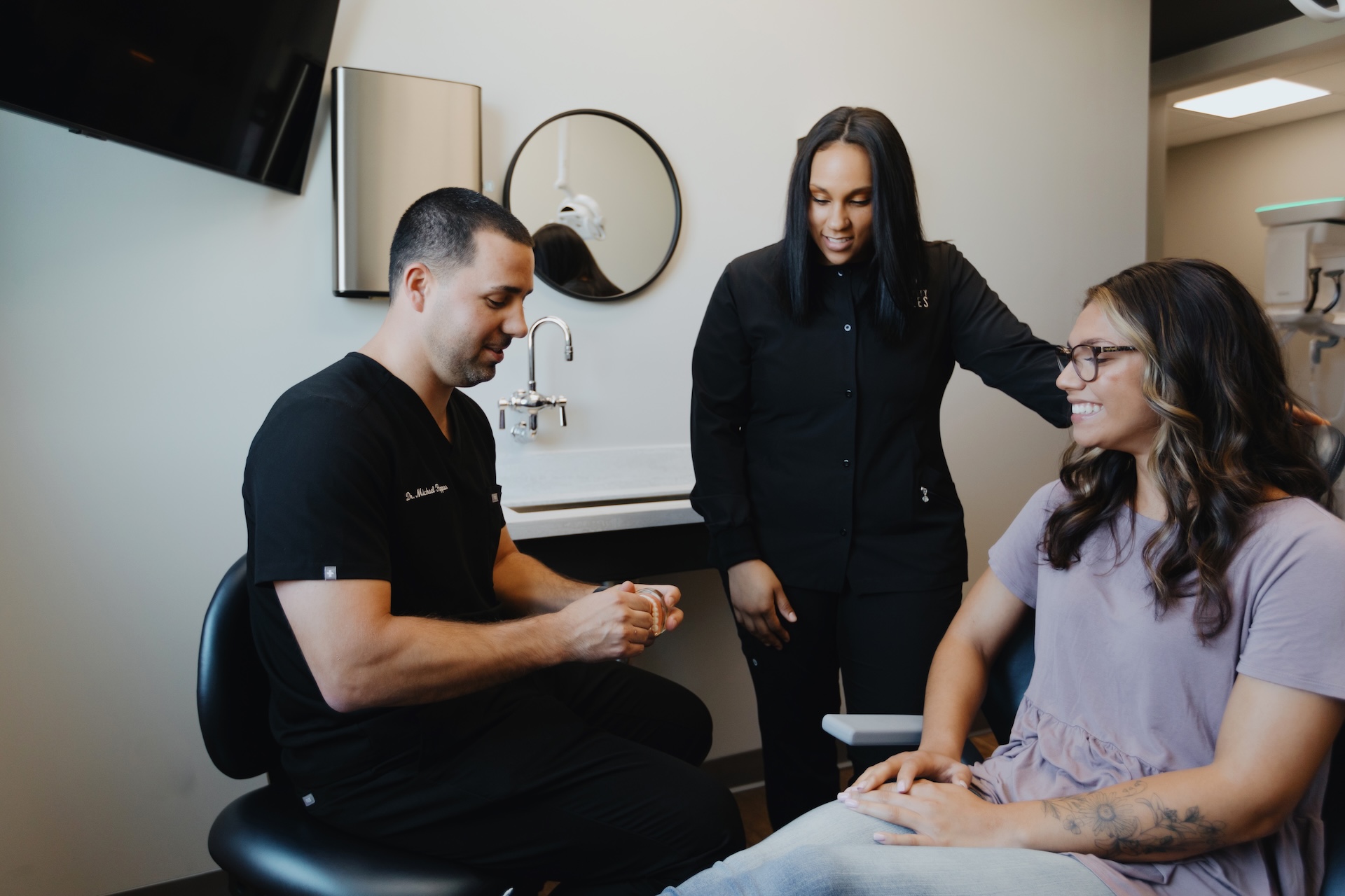 Dentist and dental assistant with patient at Grove City Smiles