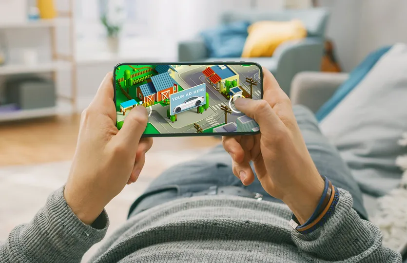 graphic showing a man playing a mobile game with an in-game ad unit