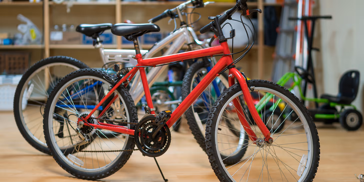 Red and silver bicycles assembled indoors for the 2026 Big Bike Giveaway by The Prescott Companies team members