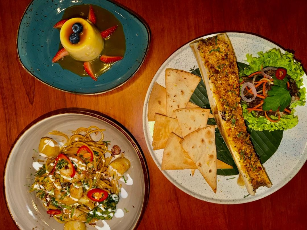 Various bowls of asian spices on a dark wood table