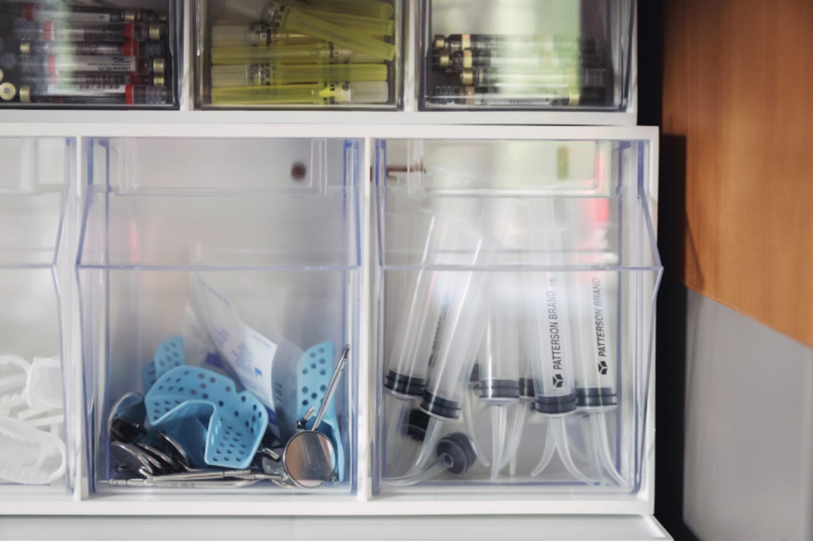 Organized dental sterilization and instrument storage containers in clinical workspace