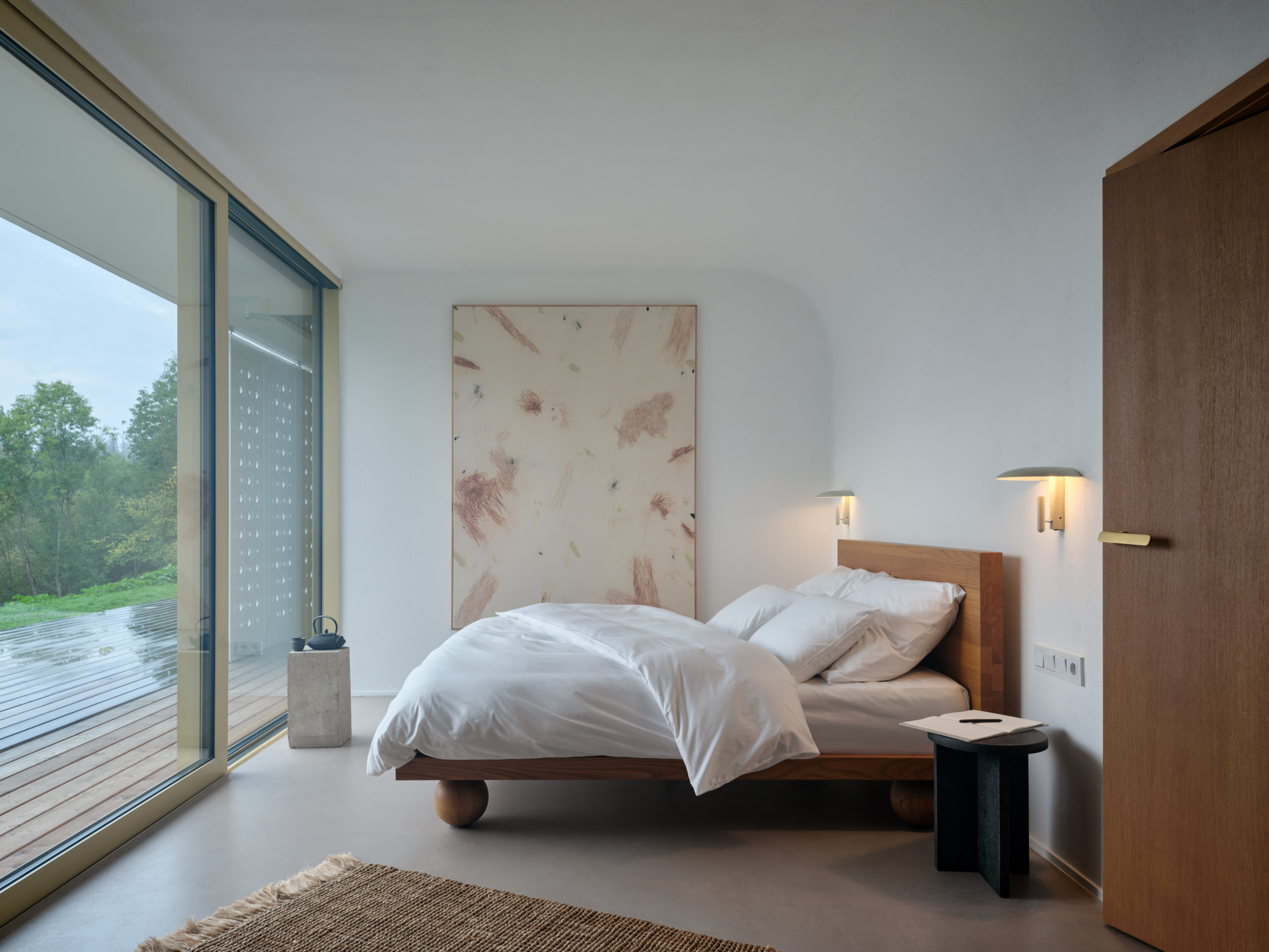 Master bedroom with floor-to-ceiling windows, wood veneer door with M&T Minimal 2.0 door handle in matte gold-like finish.
