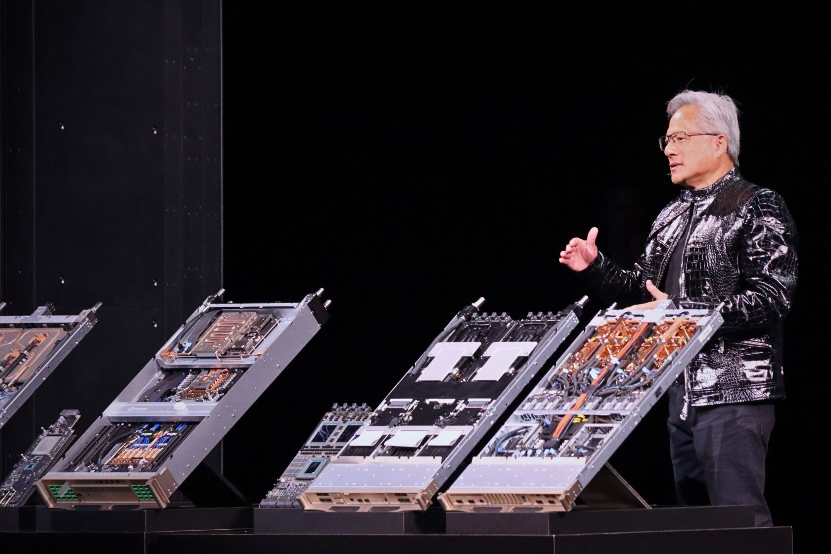 NVIDIA Founder and CEO Jensen Huang stands beside Vera Rubin AI compute boards during the NVIDIA CES 2026 press conference, showcasing next-generation CPU and GPU co-designed systems for large-scale AI computing.