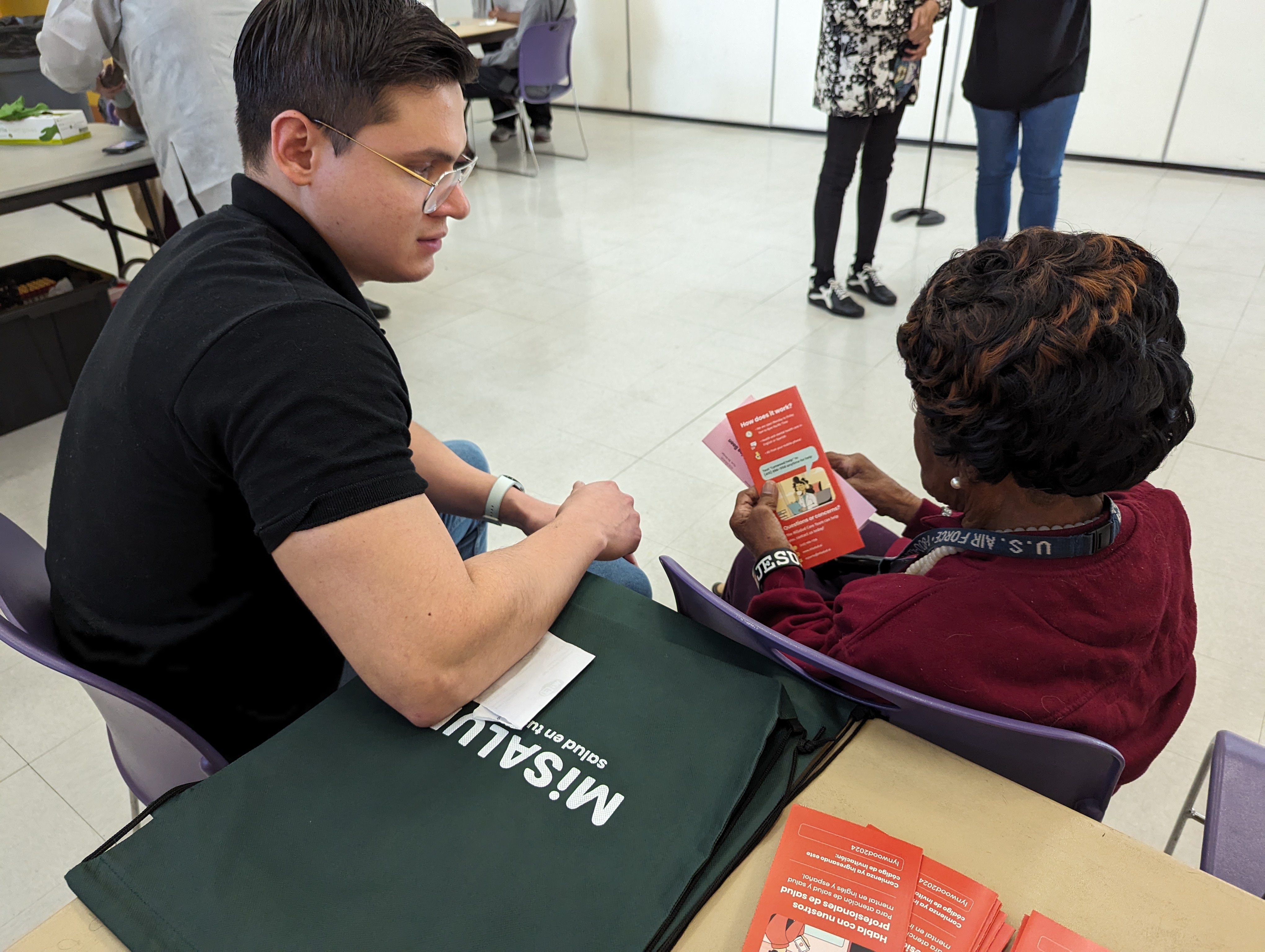 A MiSalud coach with an employee at a health fair