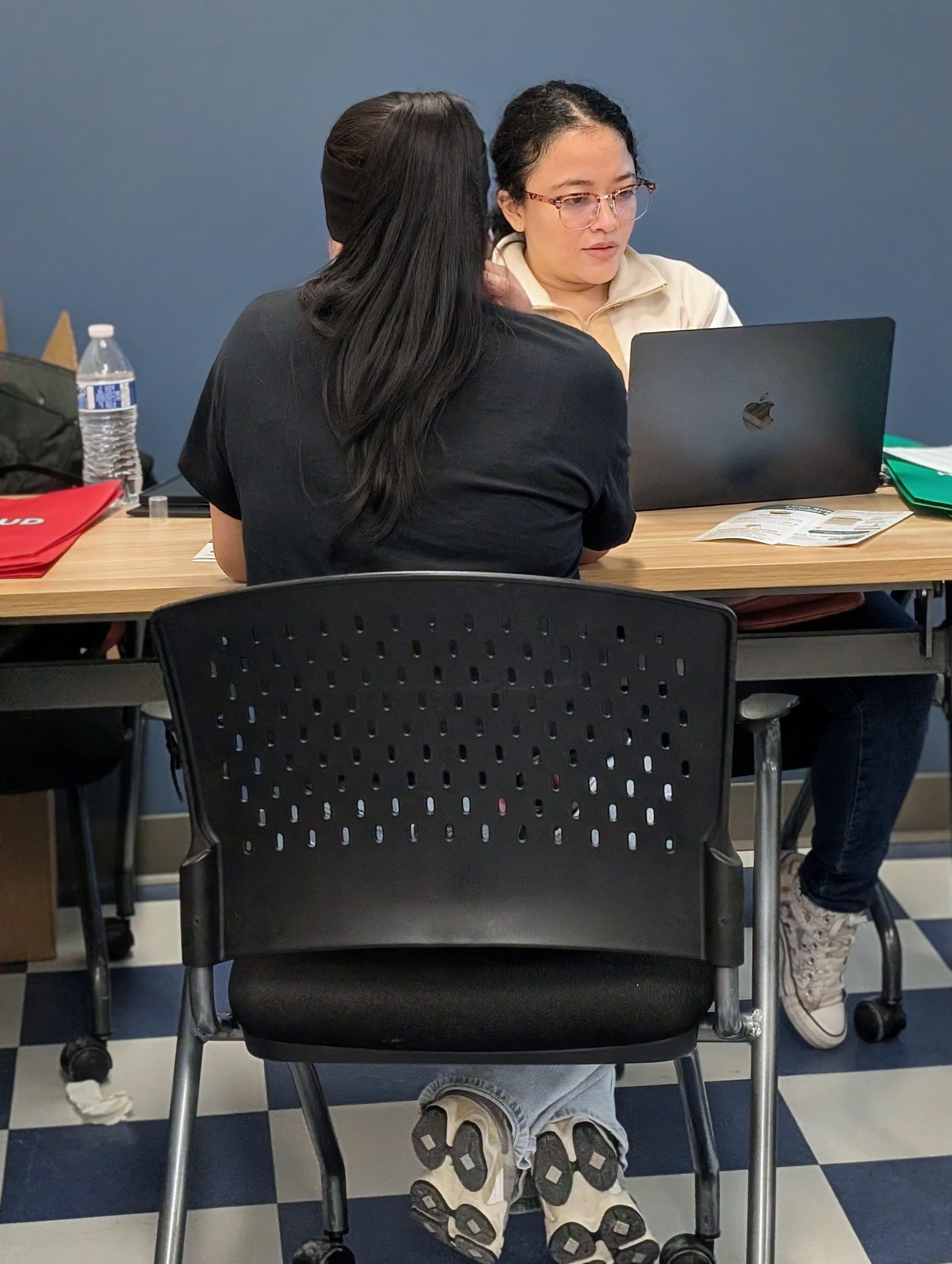 A MiSalud coach with a member at a laptop
