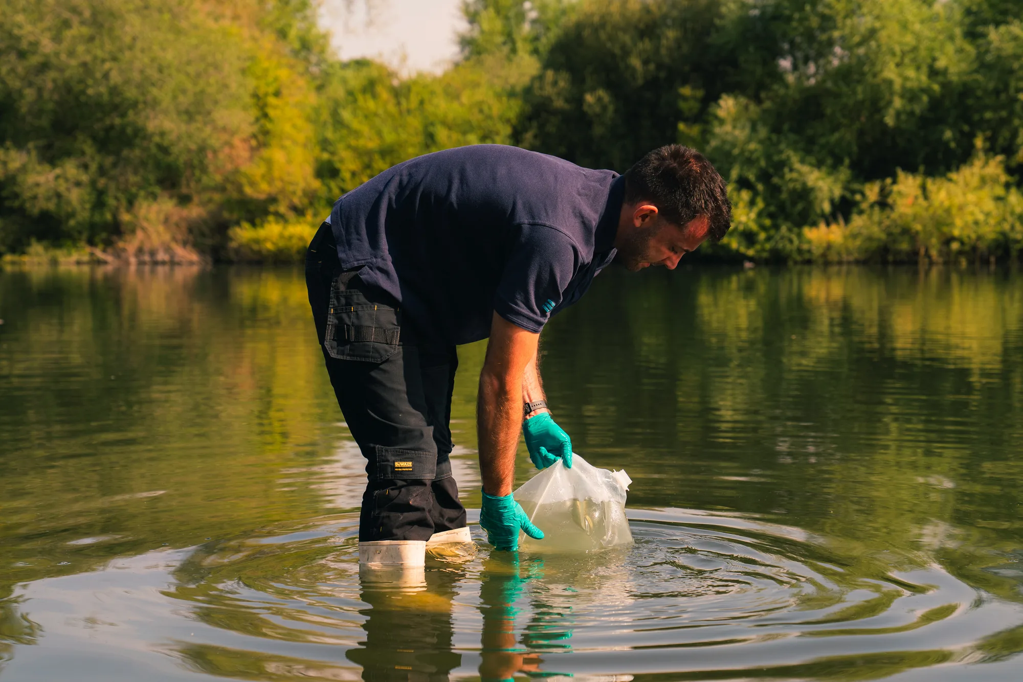 Broadwater engineer collecting a water sample for laboratory analysis.