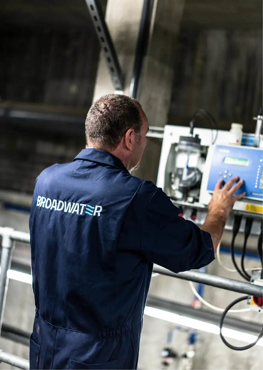 Broadwater engineer working on water treatment equipment at a school.
