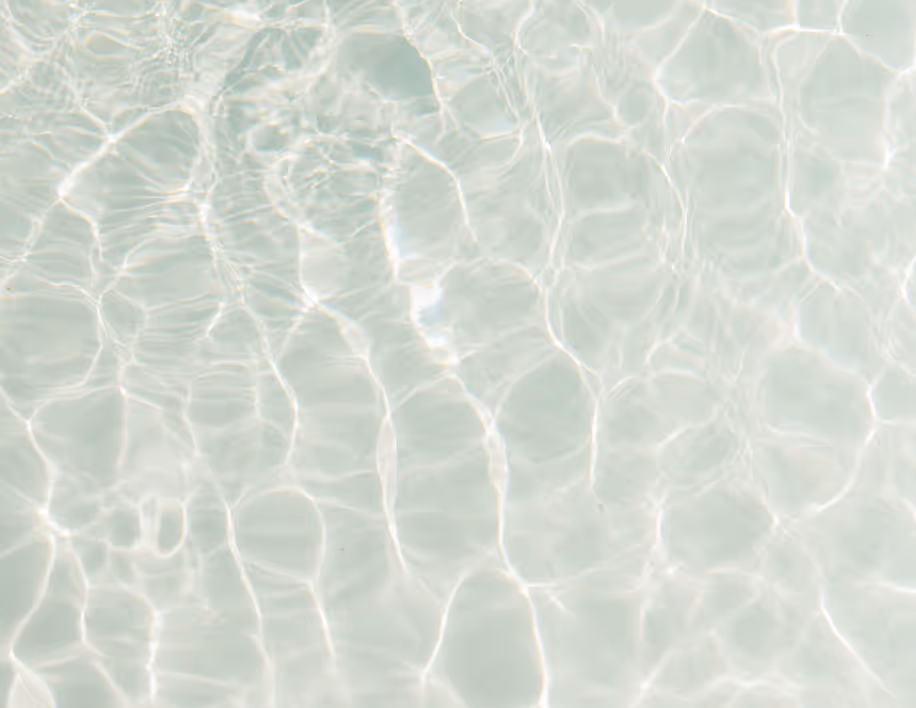 Clear water surface with light reflections creating wavy patterns.