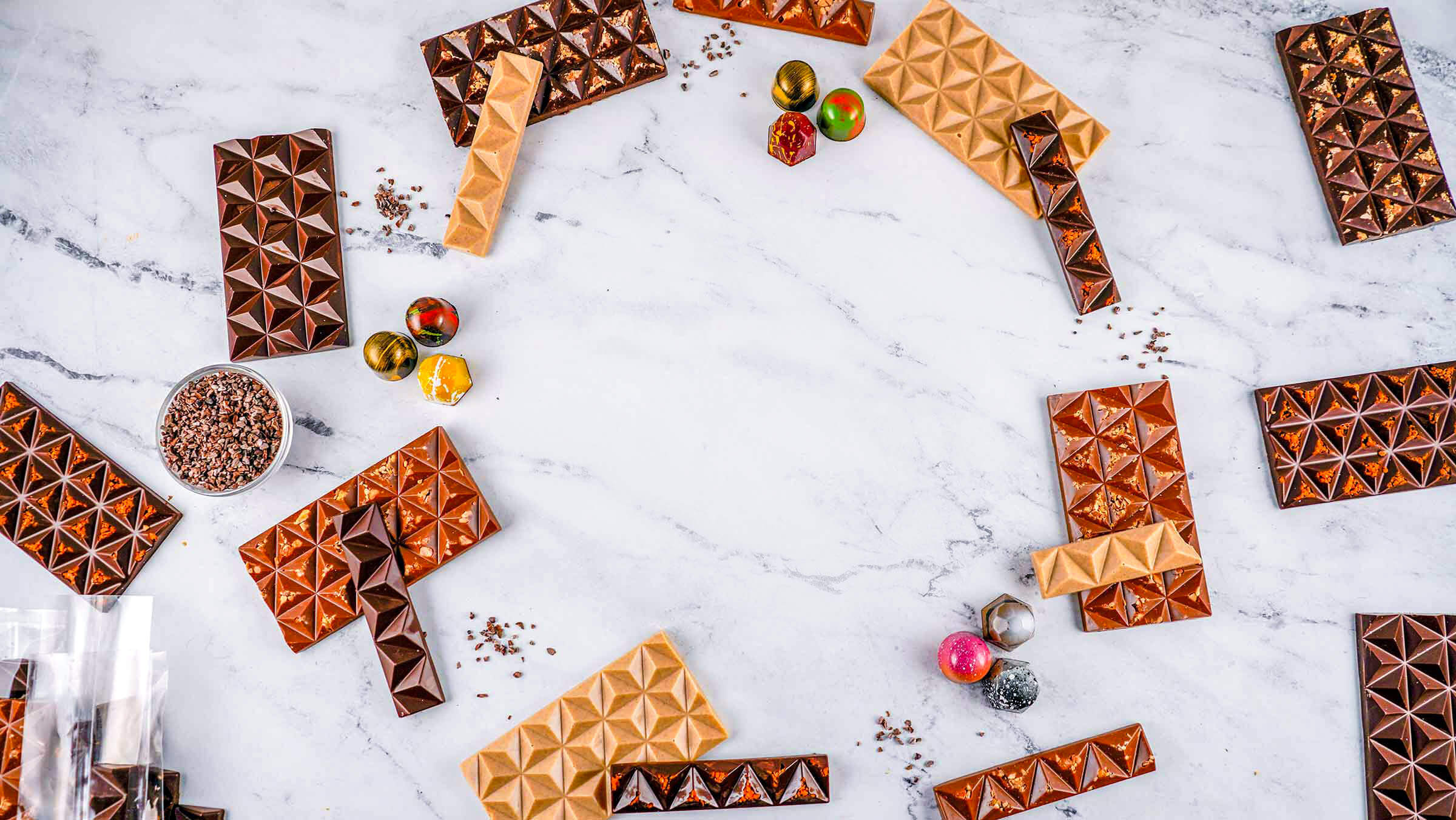 Overhead of marble table with chocolates and truffles scattered around