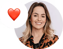 Smiling woman with wavy blonde hair wearing an animal print top, with a red heart emoji in a white speech bubble beside her.