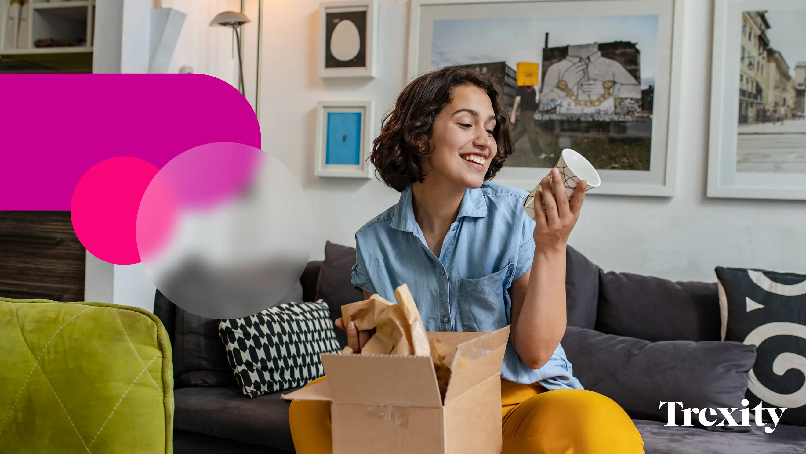 A curated lifestyle stock photograph supporting the Trexity brand identity, curated by Hovski Studio. A smiling young woman sits on a living room couch unboxing a parcel and holding up a patterned white ceramic mug. The bottom right corner features the white Trexity corporate logo wordmark, balanced on the left by an overlay of the brand's signature magenta geometric capsule vectors.