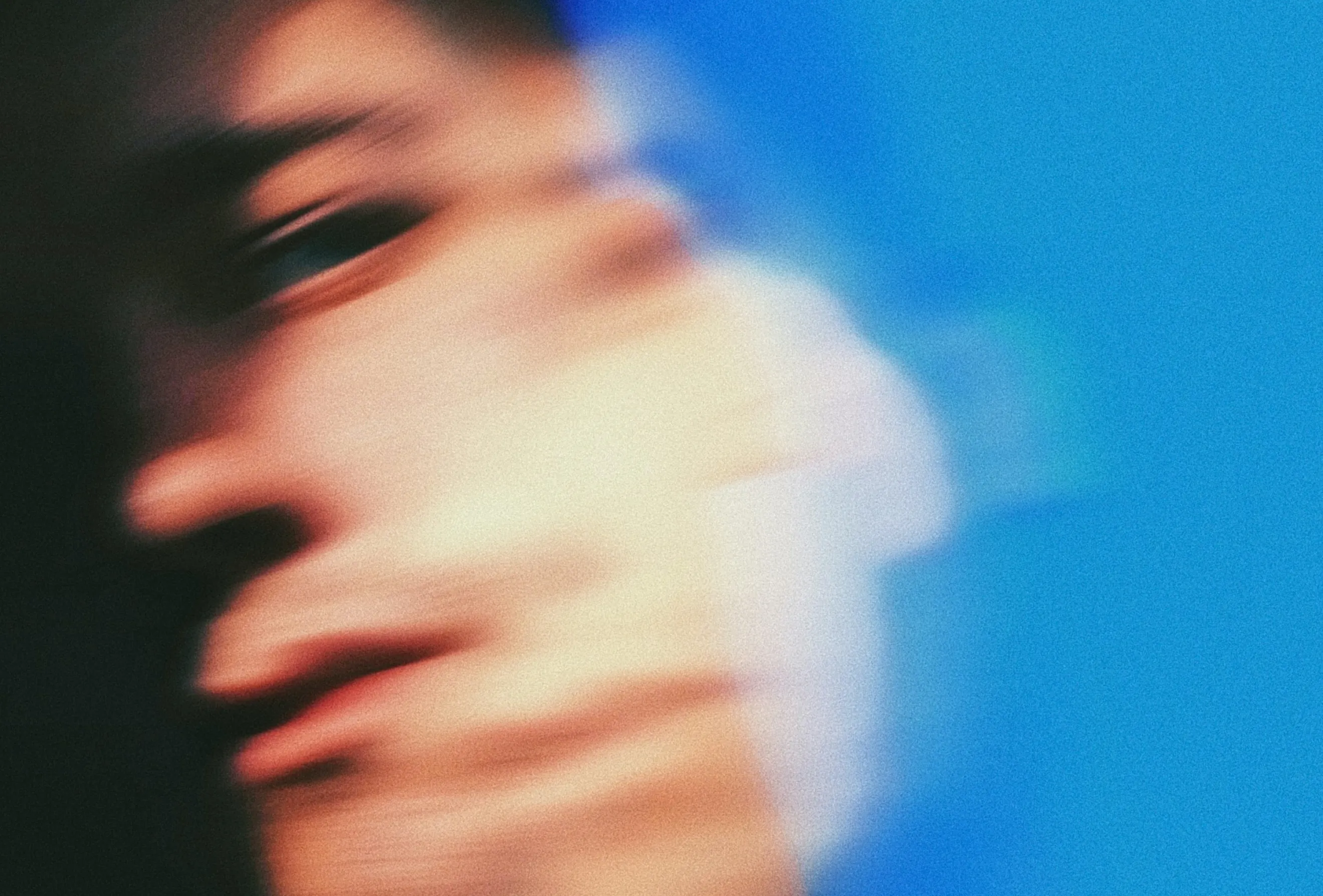 Conceptual portrait showing Psychedelics Today photography direction with motion blur, grain texture, and a blue background.