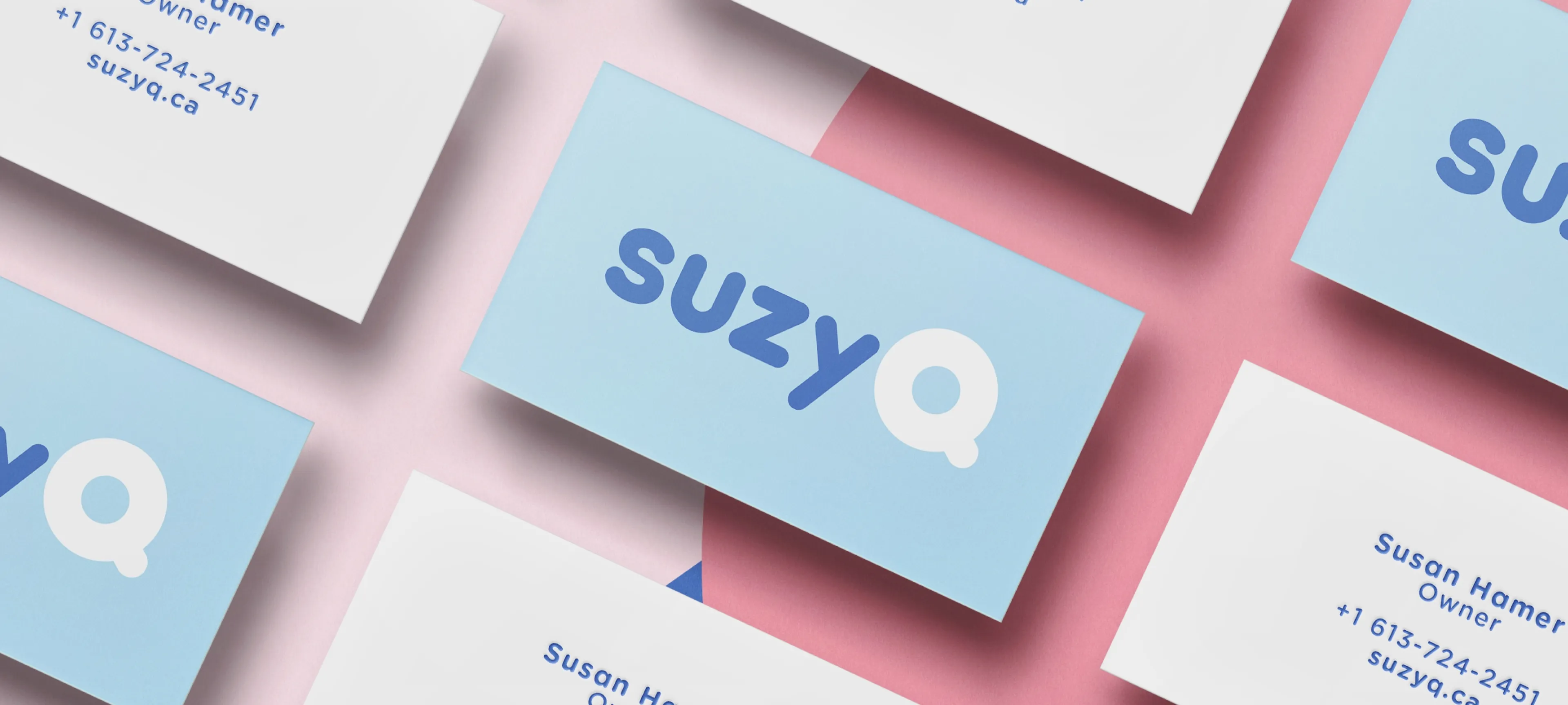 SuzyQ Doughnuts business card mockup featuring the updated logo, blue color palette, and minimalist brand details.
