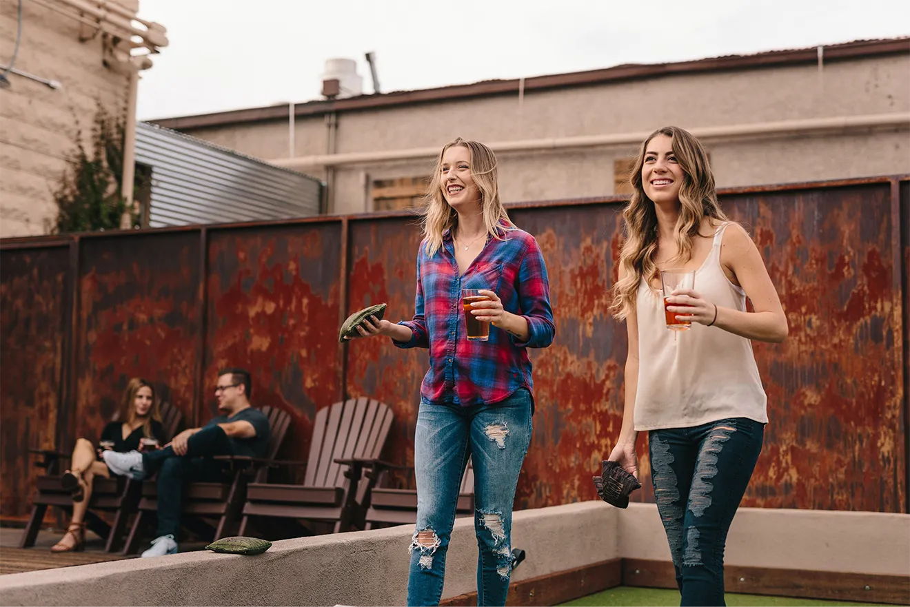 Artizen Iced Tea lifestyle photography featuring customers enjoying bottled iced tea outdoors.