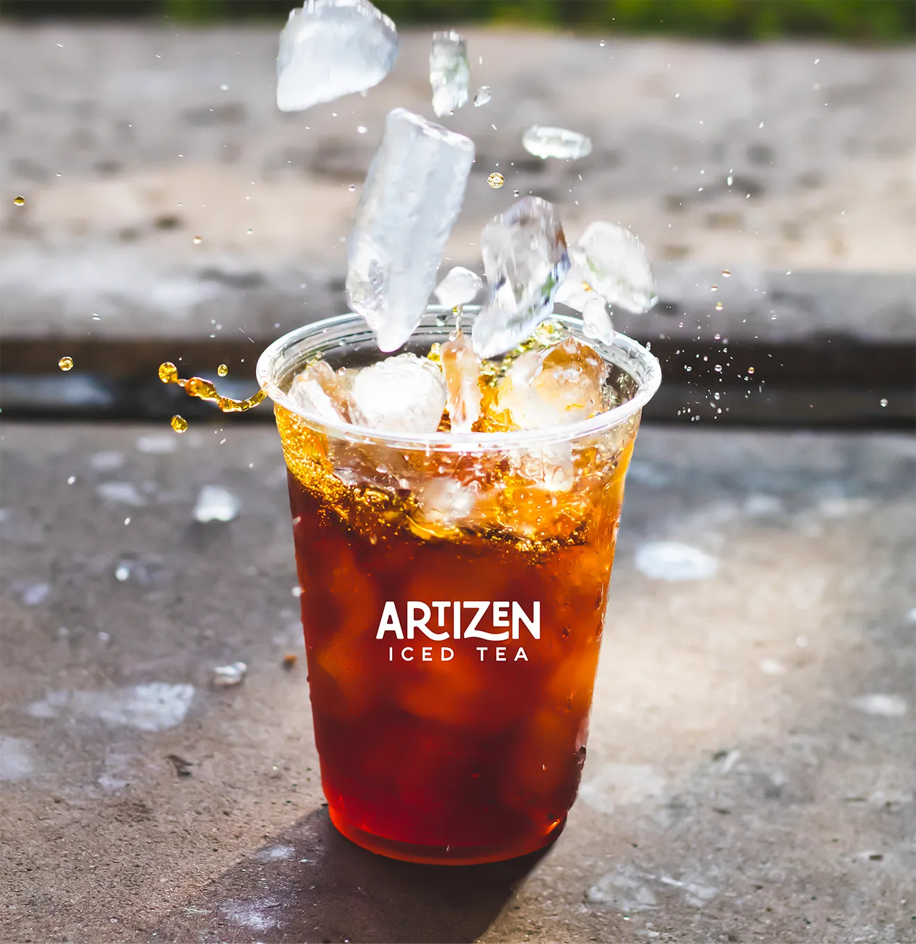 Artizen Iced Tea campaign mockup featuring logo design on a branded iced tea cup.